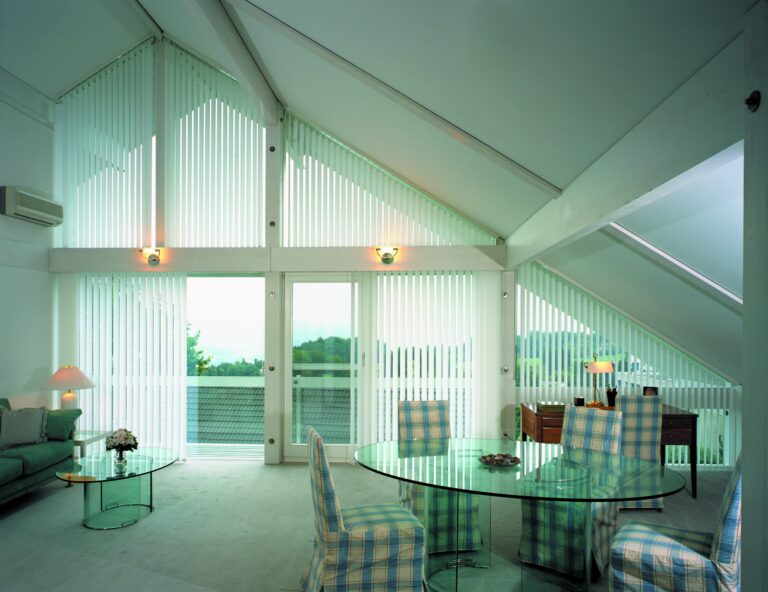 Sloping vertical blinds on an angled window