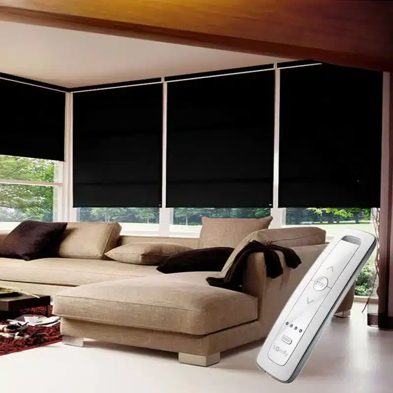 Battery vs Mains Electric Blinds: battery powered electric blinds with a handheld remote on a black roller blind